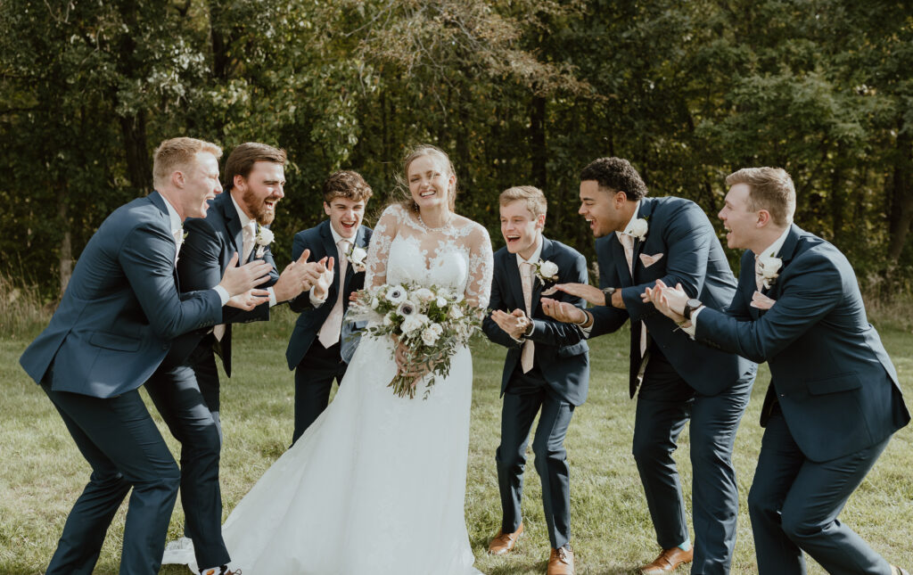 groomsmen clap for bride and laugh
