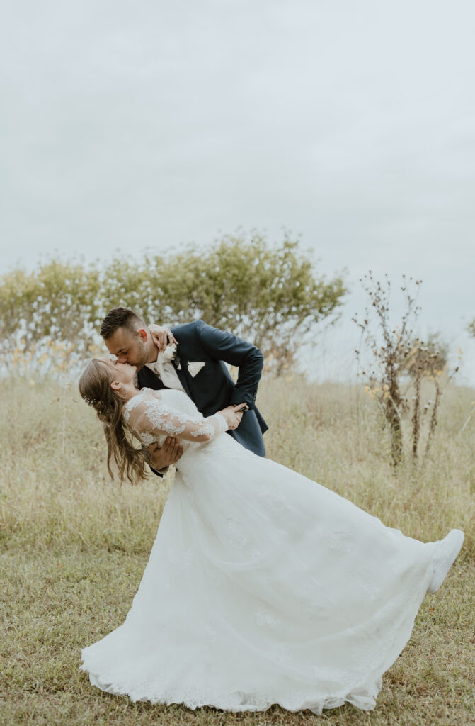 bride and groom kissing portraits after wedding ceremony