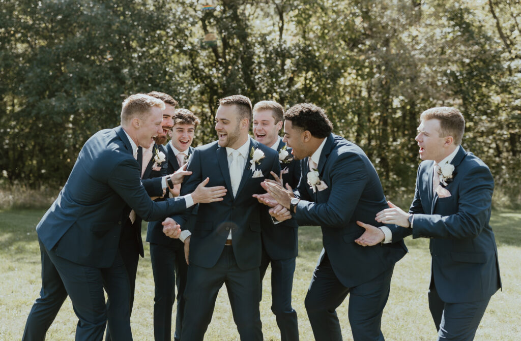 groomsmen laughing on wedding day 