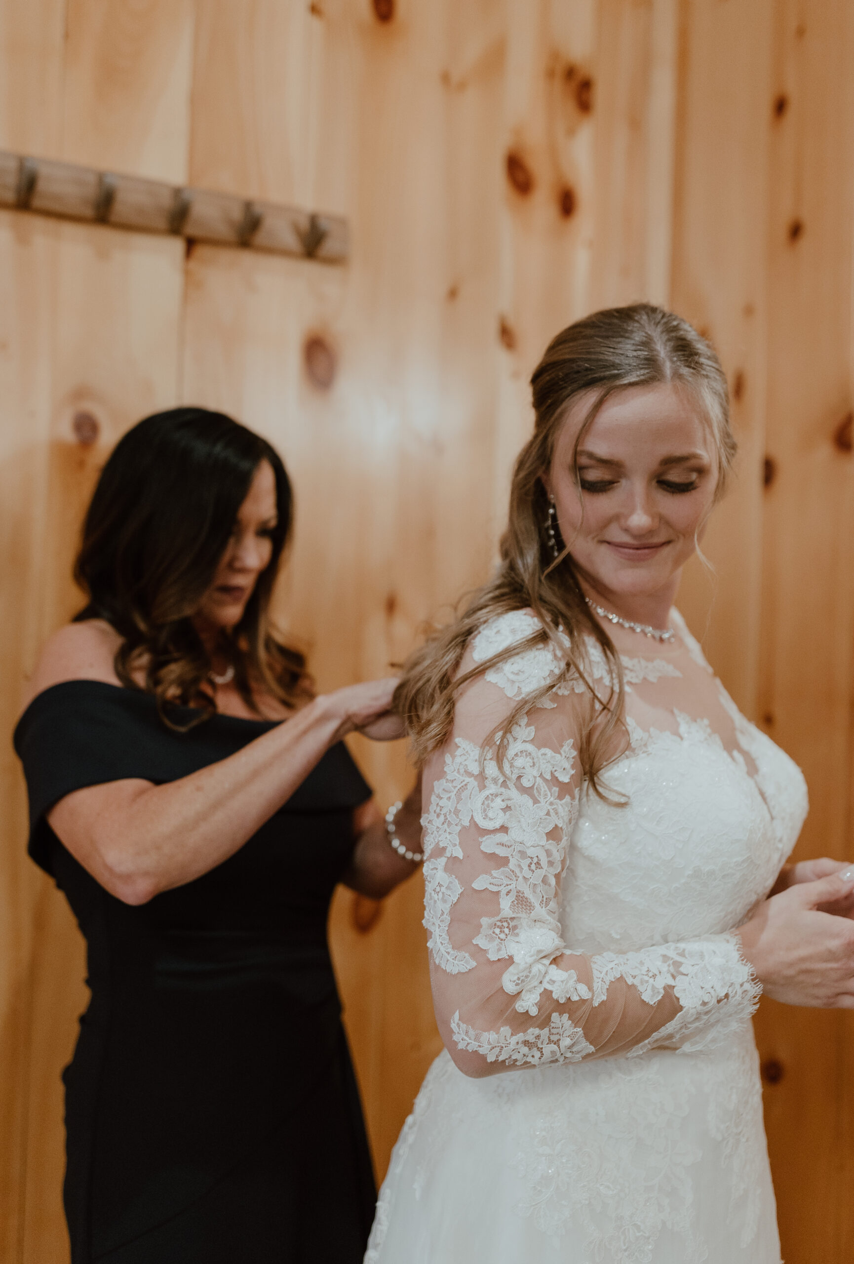bride getting ready for wedding day with mom
